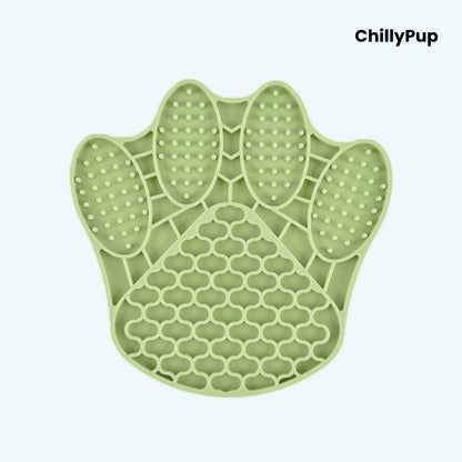 Green paw-shaped silicone mat with textured surface on a light blue background, branded 'ChillyPup'.