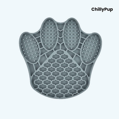 Grey paw-shaped silicone mat with textured surface on a light blue background, branded 'ChillyPup'.